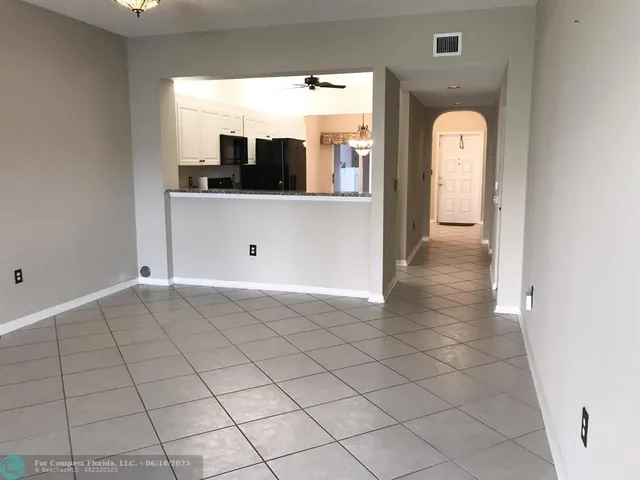 a view of a living room a bathroom with a sink and mirror