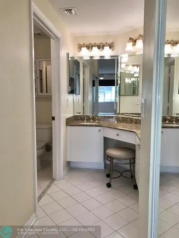 a kitchen with a sink and chairs