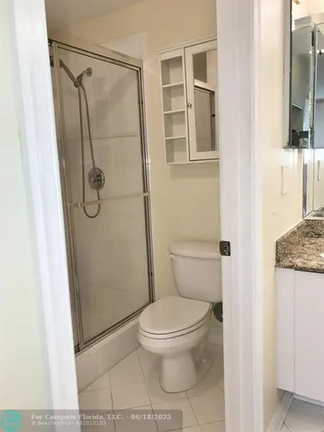 a white toilet sitting next to a bathroom