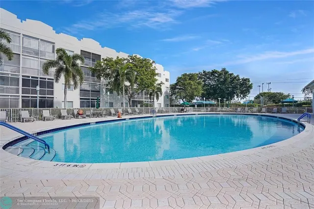 a swimming pool with outdoor seating and yard