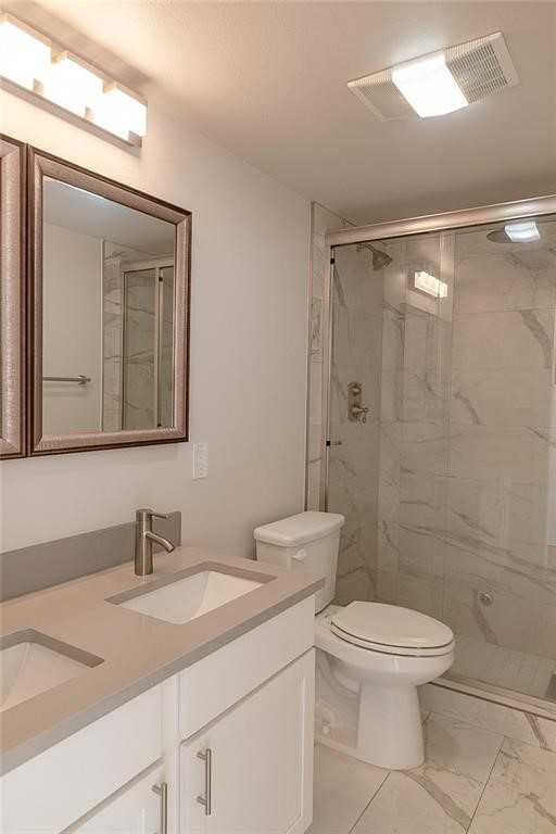 2509 Del Curto Road, Unit A Austin, TX 78704 - Photo 14 of 23 a bathroom with a granite countertop sink toilet a mirror and shower