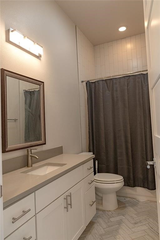 2509 Del Curto Road, Unit A Austin, TX 78704 - Photo 15 of 23 a bathroom with a toilet a sink and a mirror