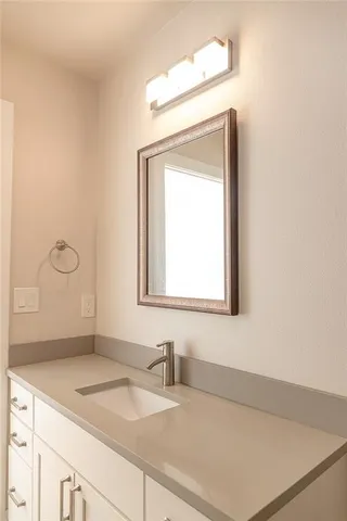 a bathroom with a sink a vanity and a mirror