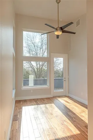 a view of a room with a window and a ceiling fan