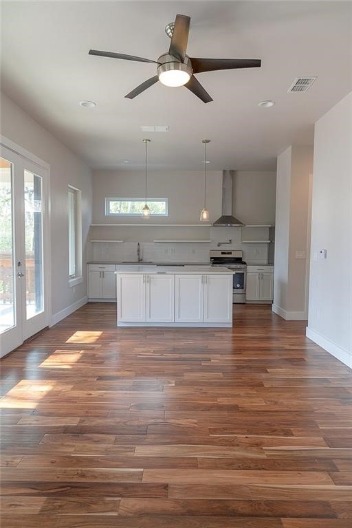 2509 Del Curto Road, Unit A Austin, TX 78704 - Photo 4 of 23 a view of a kitchen with a stove cabinets and wooden floor