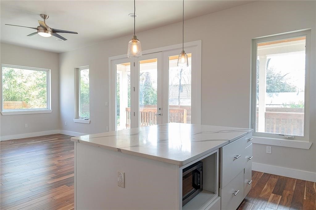 2509 Del Curto Road, Unit A Austin, TX 78704 - Photo 7 of 23 a view of an empty room with a window and wooden floor