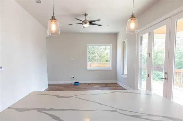 a view of a livingroom with a ceiling fan and window