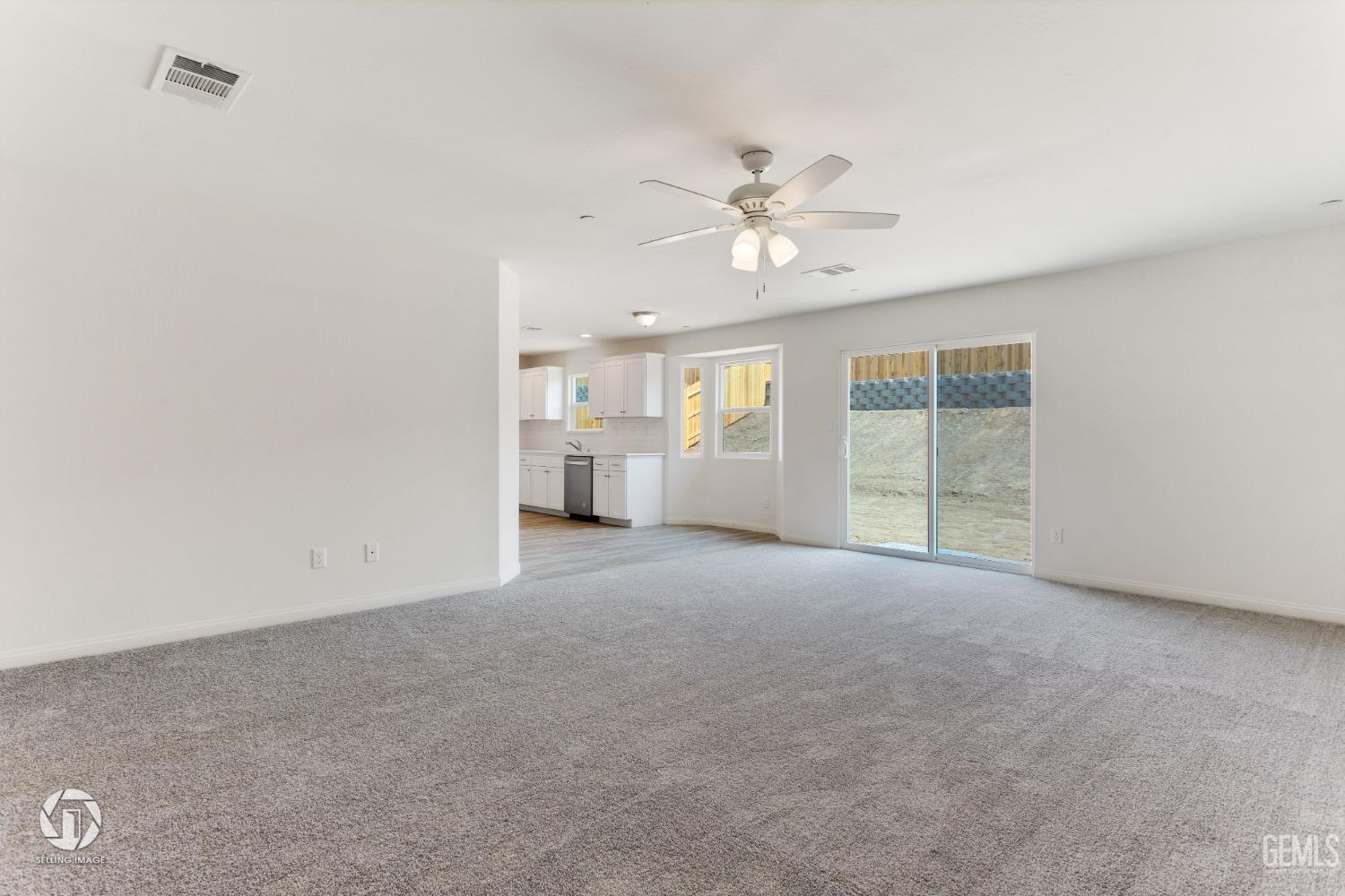 Undisclosed Address Shafter, CA 93263 - Photo 11 of 33 a view of a big room with windows and chandelier fan