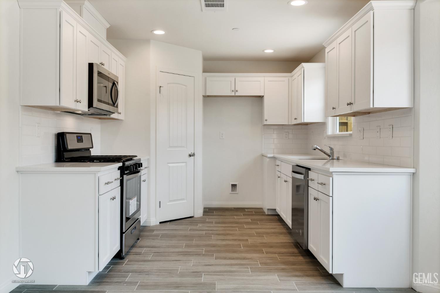 Undisclosed Address Shafter, CA 93263 - Photo 13 of 33 a kitchen with stainless steel appliances granite countertop a refrigerator sink and white cabinets