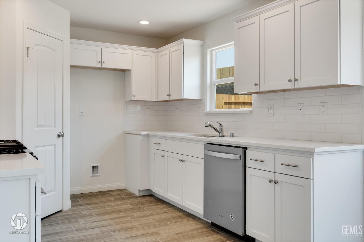 Undisclosed Address Shafter, CA 93263 - Photo 14 of 33 a kitchen with white cabinets and sink