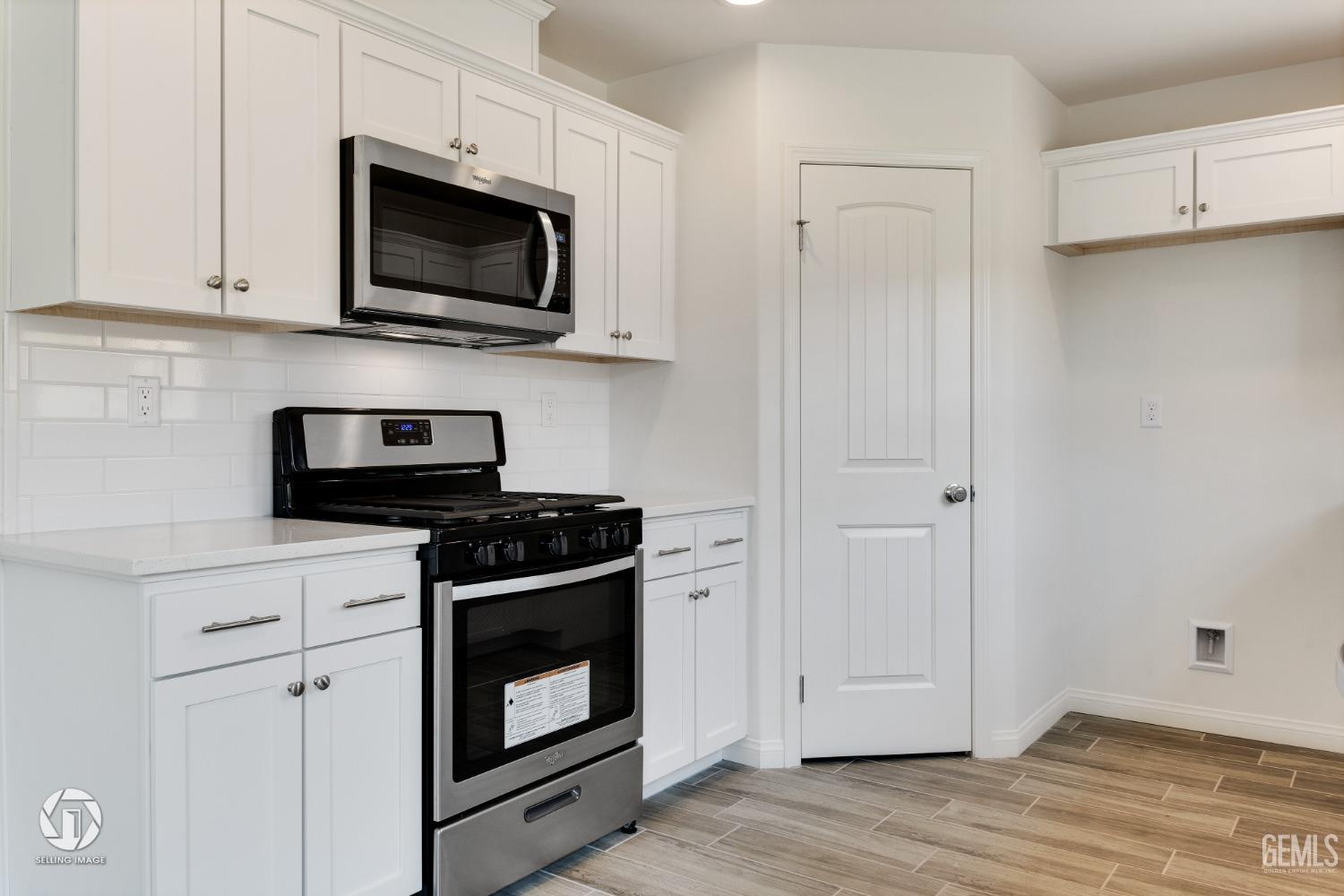 Undisclosed Address Shafter, CA 93263 - Photo 15 of 33 a kitchen with stainless steel appliances white cabinets and a stove top oven