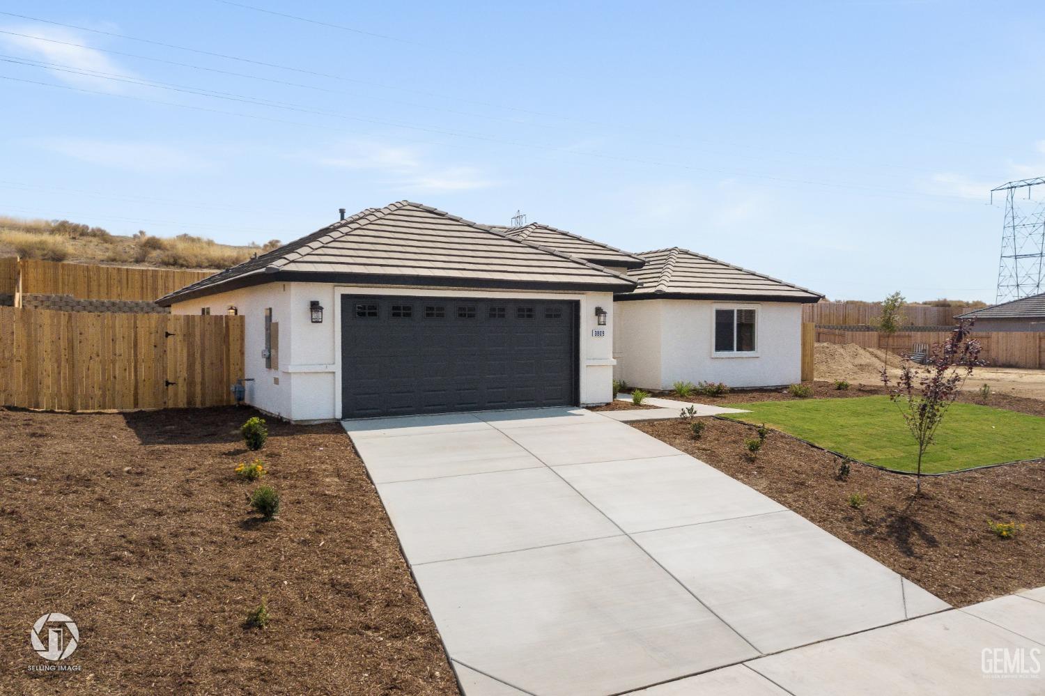 Undisclosed Address Shafter, CA 93263 - Photo 2 of 33 a front view of a house with a yard