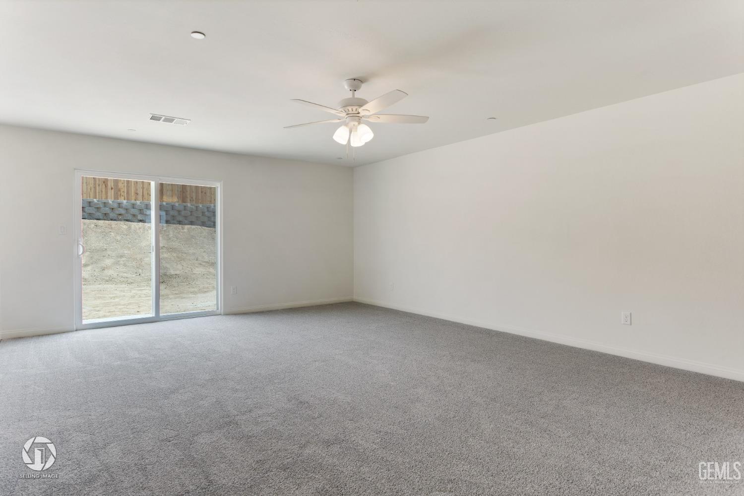 Undisclosed Address Shafter, CA 93263 - Photo 8 of 33 an empty room with windows and ceiling fan