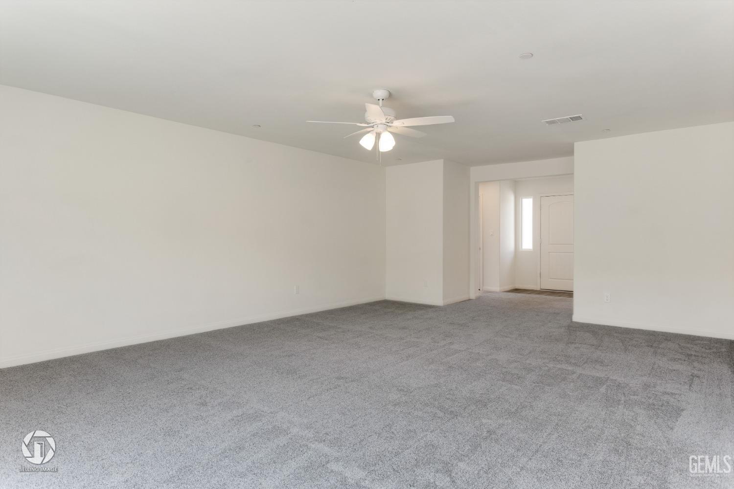 Undisclosed Address Shafter, CA 93263 - Photo 10 of 33 an empty room with chandelier fan and windows