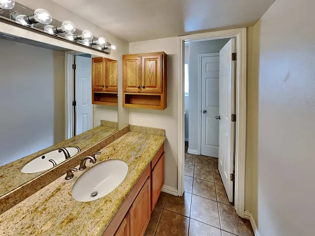 a bathroom with a sink a mirror and toilet