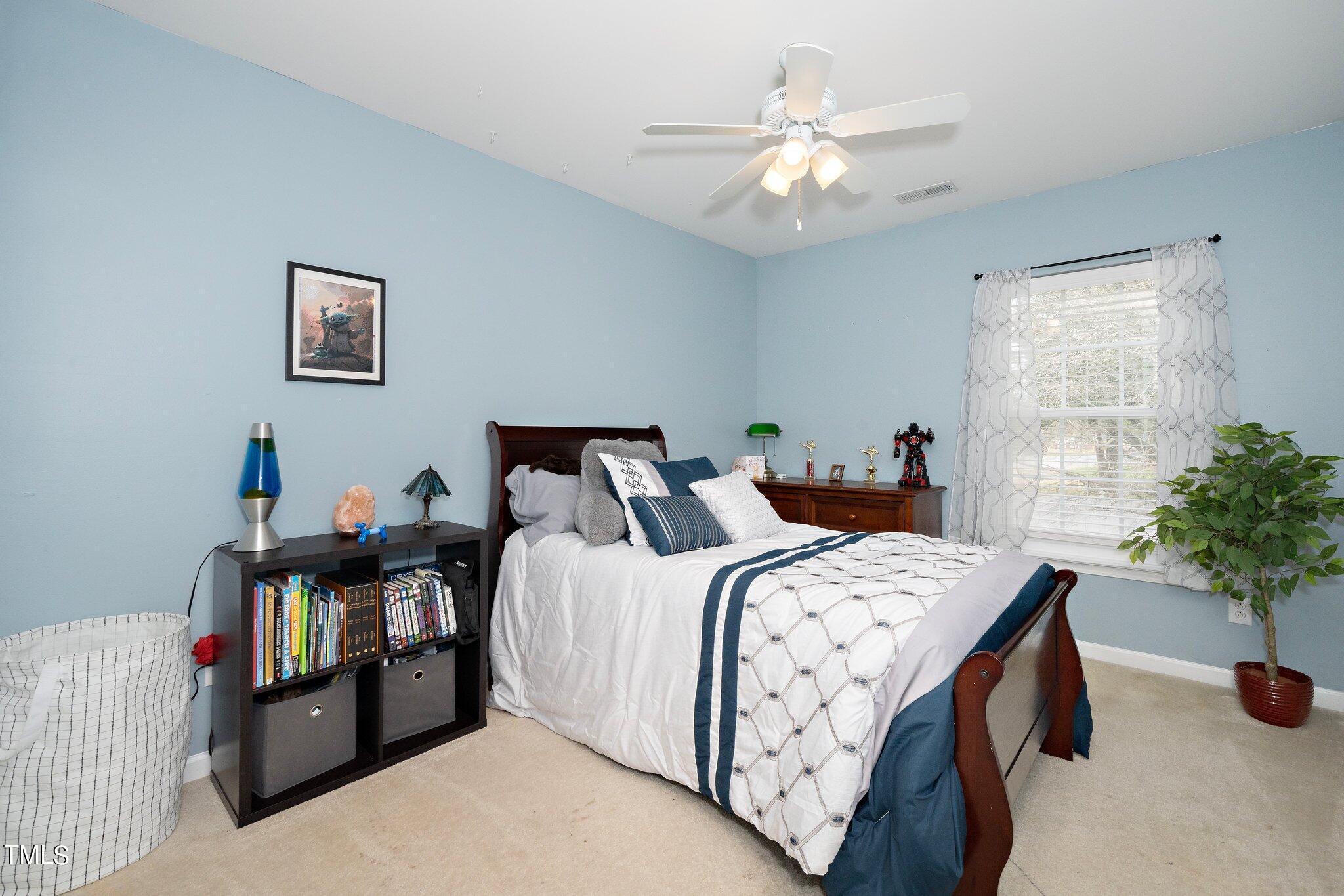 120 Solheim Lane Raleigh, NC 27603 - Photo 8 of 26 a bedroom with bed and a window