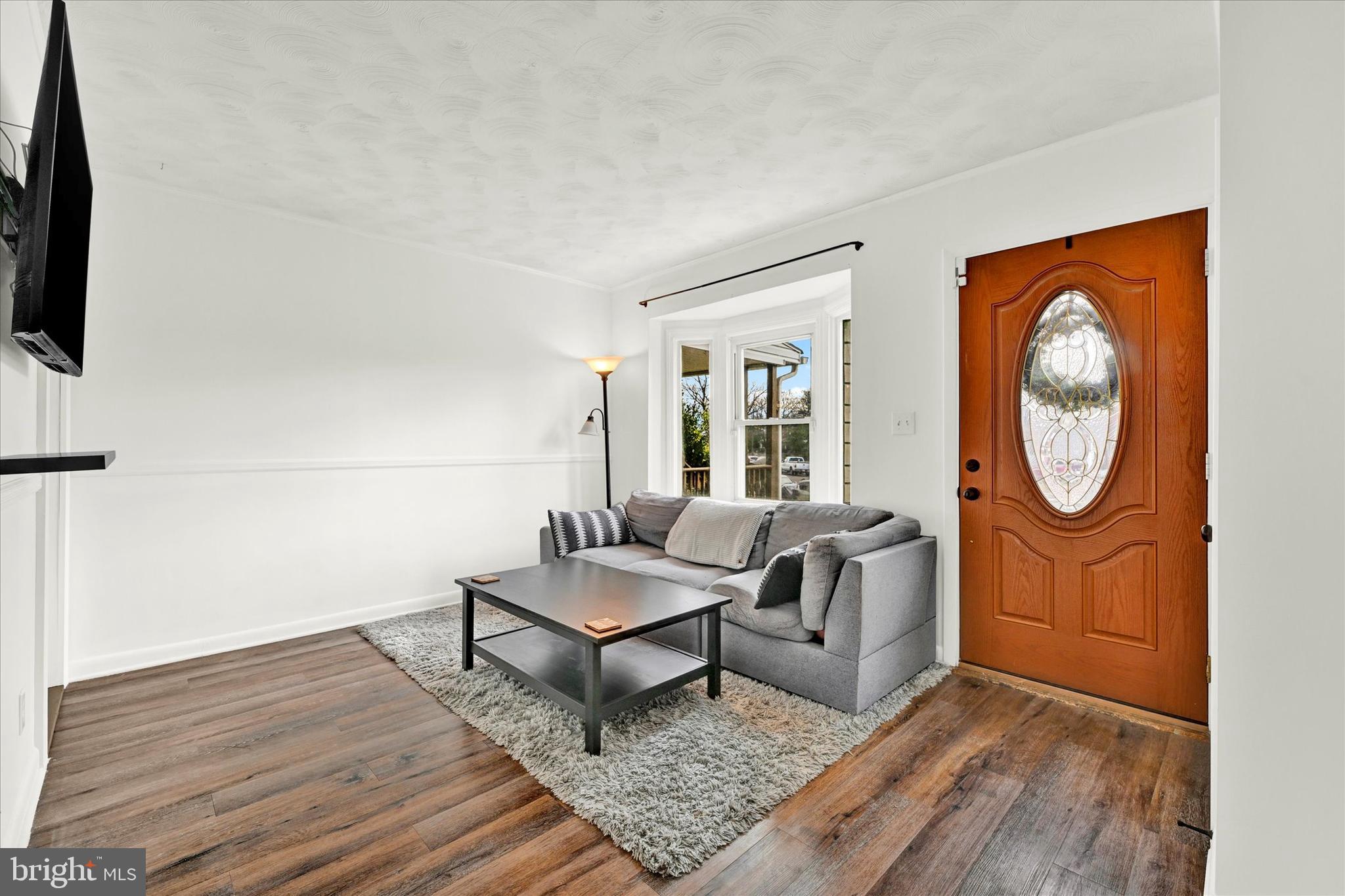 712 Arncliffe Road Essex, MD 21221 - Photo 3 of 20 entryway/living room with LVP
