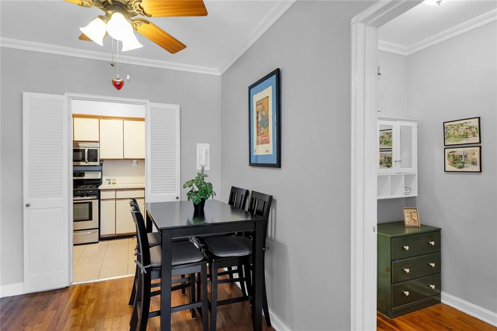 9201 Shore Road, Unit C701 Brooklyn, NY 11209 - Photo 4 of 9 a view of a dining room with furniture and wooden floor