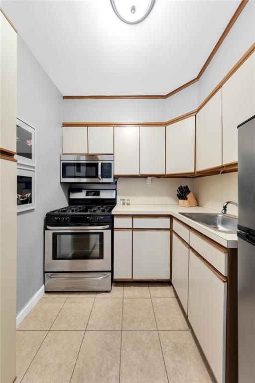 9201 Shore Road, Unit C701 Brooklyn, NY 11209 - Photo 5 of 9 a kitchen with a stove and a microwave