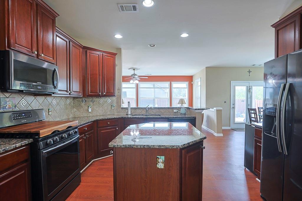 300 Hampton Place Canton, GA 30115 - Photo 14 of 82 a kitchen with granite countertop stainless steel appliances and wooden cabinets