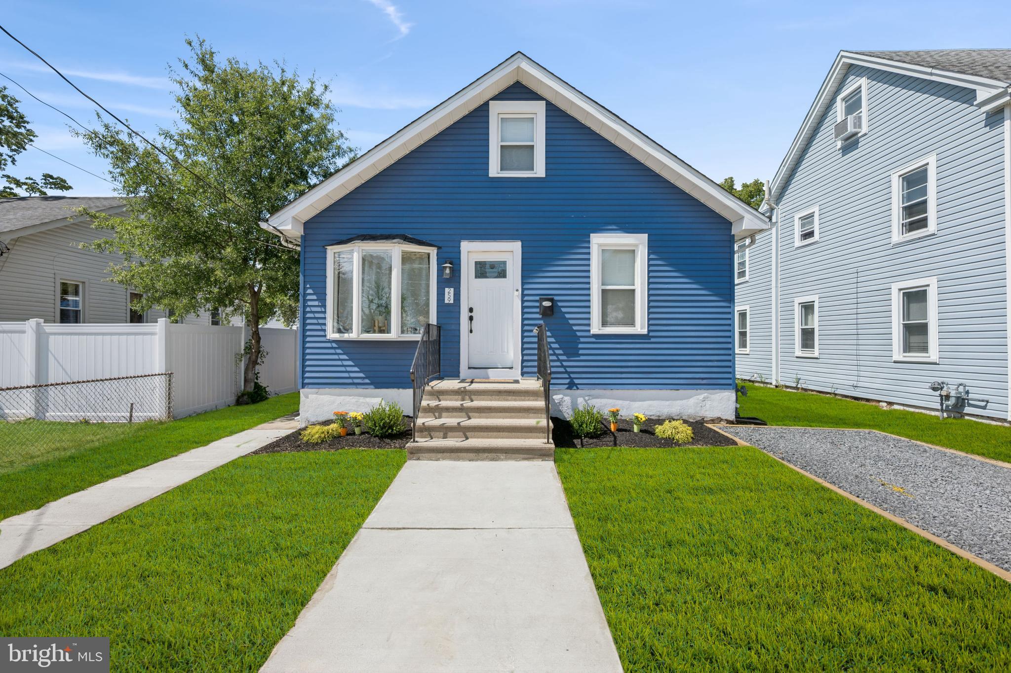 a front view of a house with a yard and garden