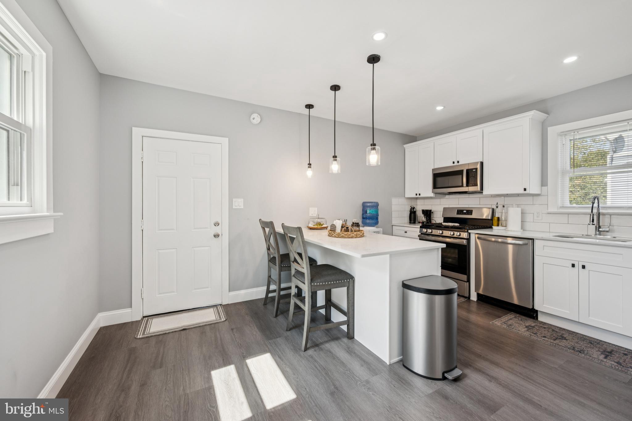 259 Hooker Street Riverside, NJ 08075 - Photo 11 of 25 a kitchen with a sink a microwave and cabinets