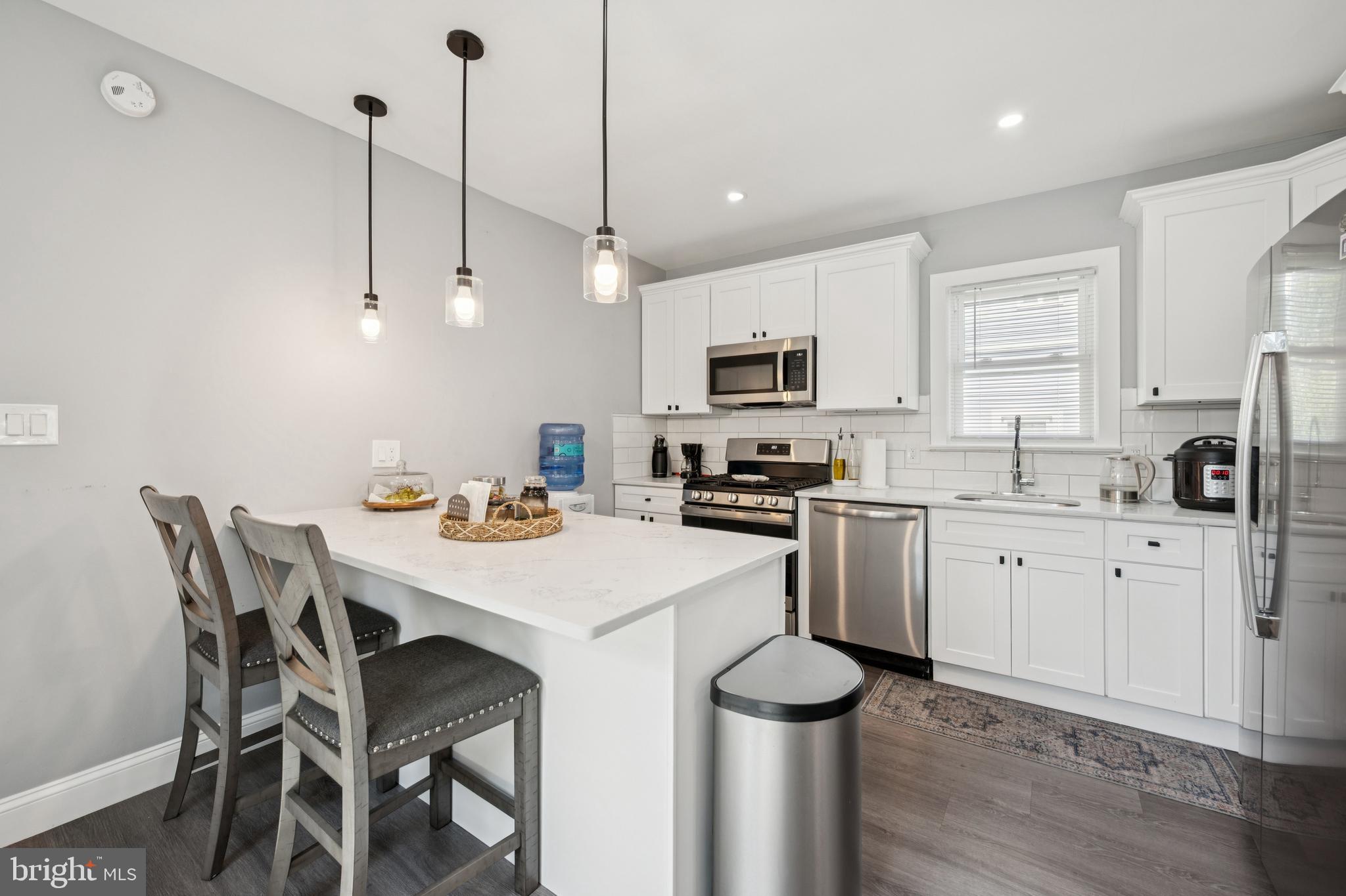 259 Hooker Street Riverside, NJ 08075 - Photo 12 of 25 a kitchen with white cabinets and white appliances