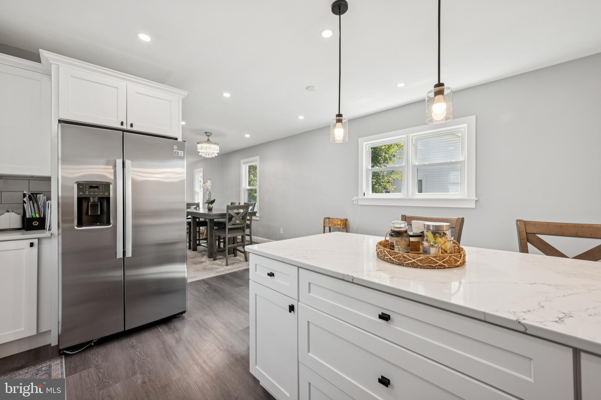 259 Hooker Street Riverside, NJ 08075 - Photo 15 of 25 a kitchen with a refrigerator chandelier and wooden floor