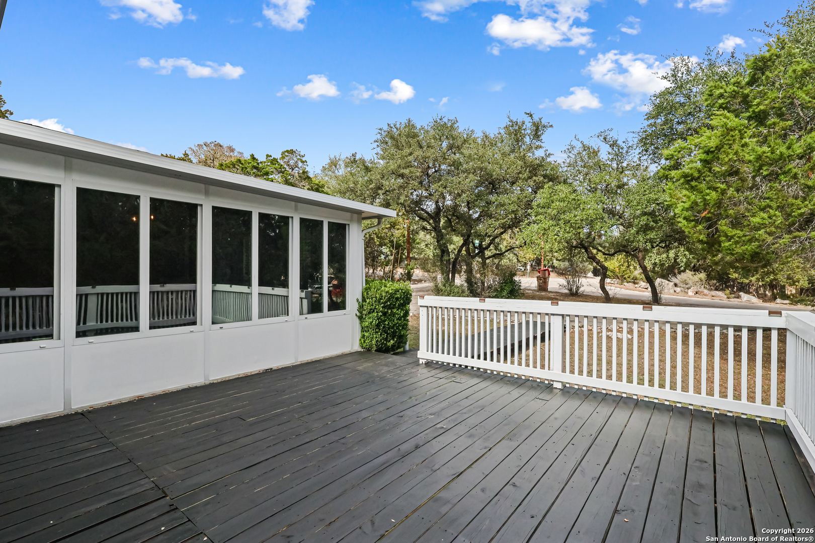 162 Canyon View Court Spring Branch, TX 78070 - Photo 5 of 44 a view of deck with wooden floor and fence with a floor to ceiling window and wooden floor