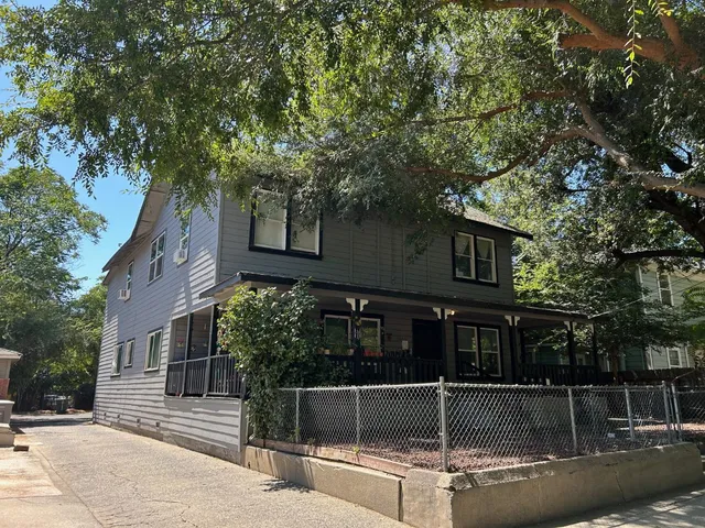 a view of a house with a large tree