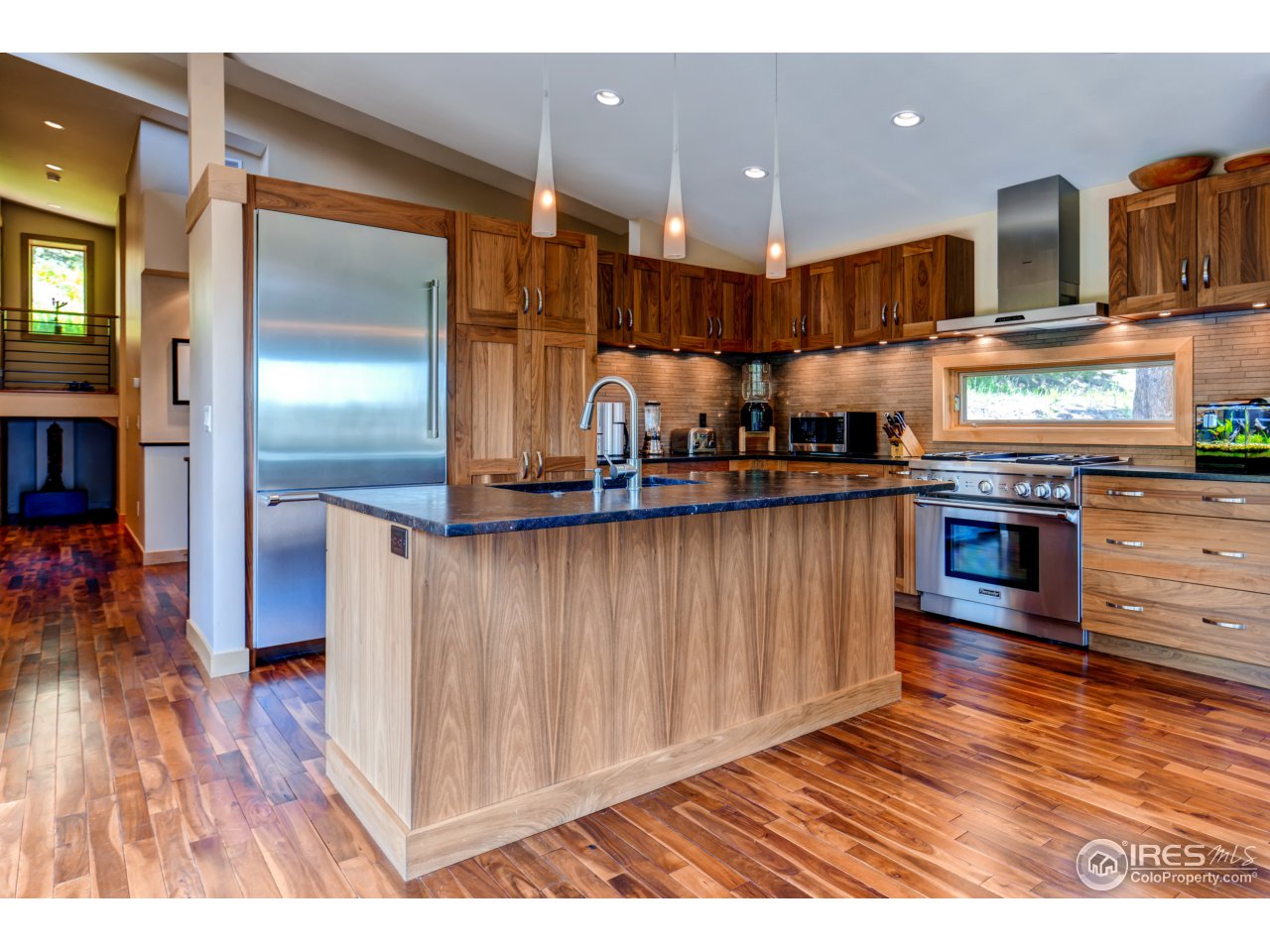 153 Brook Road Boulder, CO 80302 - Photo 6 of 25 a kitchen with stainless steel appliances granite countertop a refrigerator a stove and a wooden floors