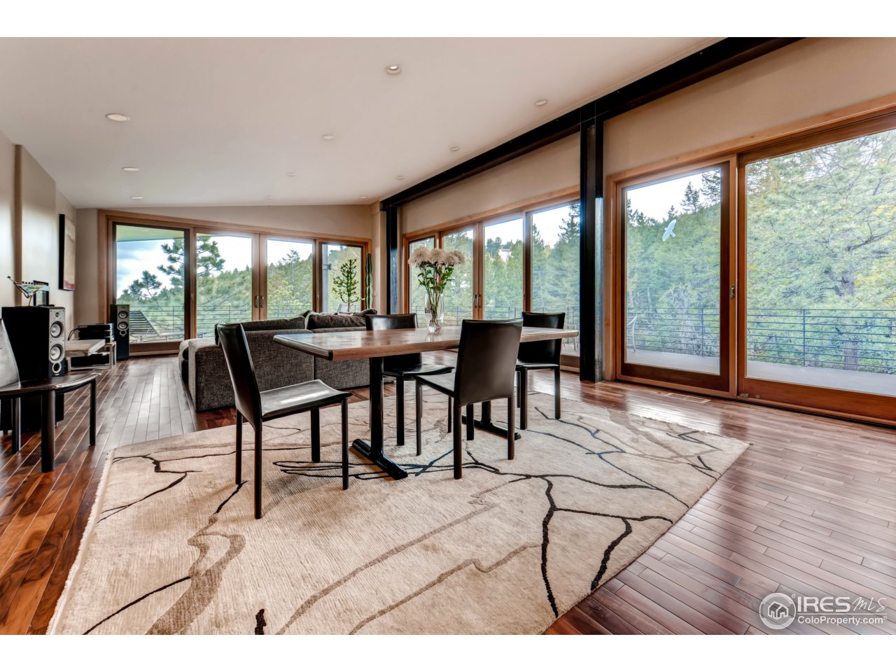 153 Brook Road Boulder, CO 80302 - Photo 7 of 25 a view of a dining room with furniture large windows and wooden floor