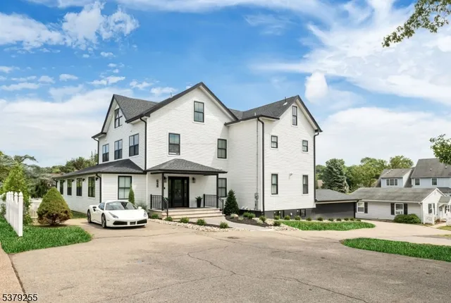 a front view of a house with a garden and patio