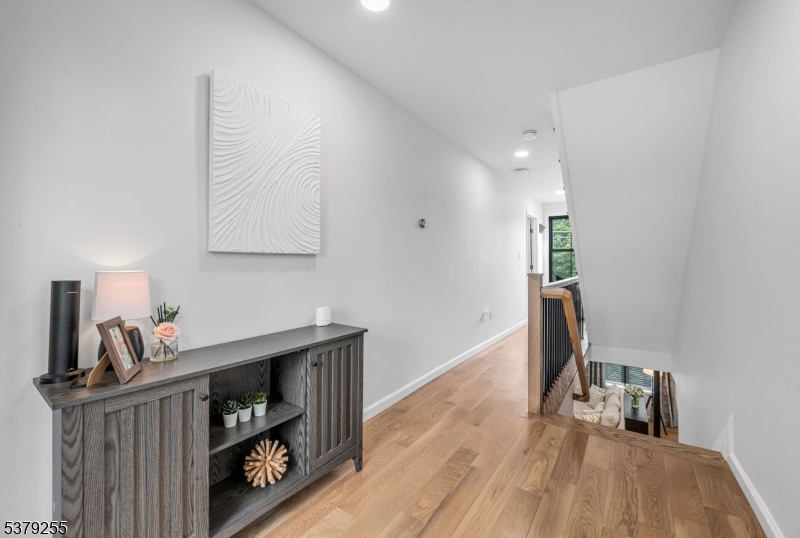 648 Black Oak Ridge Road Wayne, NJ 07470 - Photo 21 of 50 a hallway with a view of living room with wooden floor