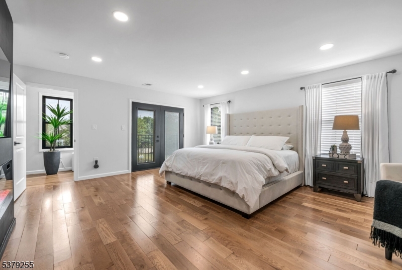 648 Black Oak Ridge Road Wayne, NJ 07470 - Photo 23 of 50 a spacious bedroom with a bed and wooden floor