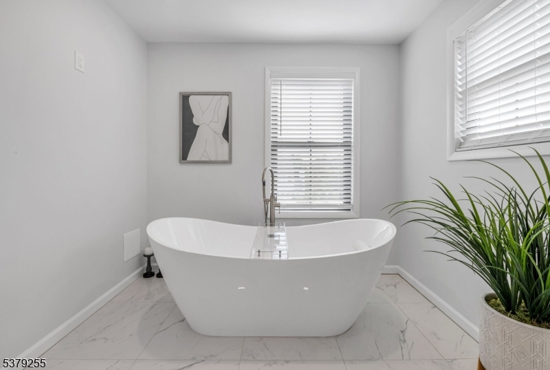 648 Black Oak Ridge Road Wayne, NJ 07470 - Photo 30 of 50 a white bath tub sitting in a bathroom