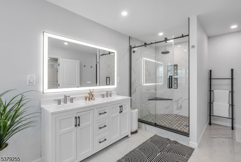 648 Black Oak Ridge Road Wayne, NJ 07470 - Photo 31 of 50 a bathroom with a double vanity sink mirror double and shower