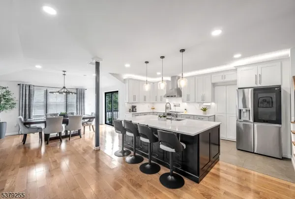 a large kitchen with a table and chairs
