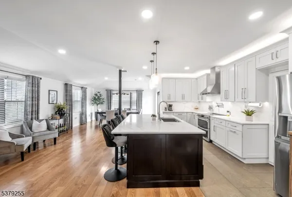 a kitchen with a sink a stove a dining table and chairs