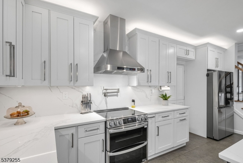 648 Black Oak Ridge Road Wayne, NJ 07470 - Photo 9 of 50 a kitchen with stainless steel appliances a stove a refrigerator and cabinets