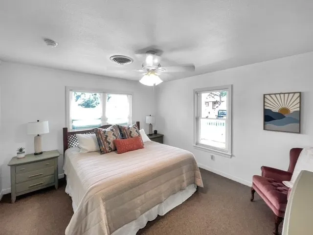 a bedroom with a large bed and a chandelier