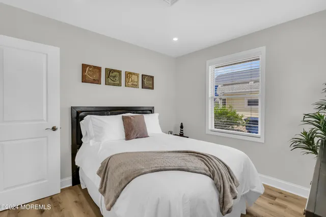 a large bed sitting in a bedroom next to a window