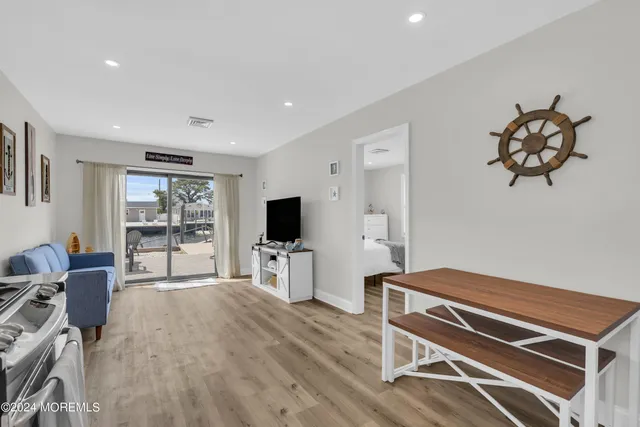 a room with furniture a flat screen tv and a window