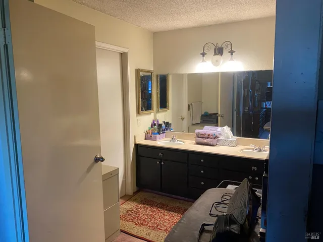 a living room with furniture a rug and a flat screen tv