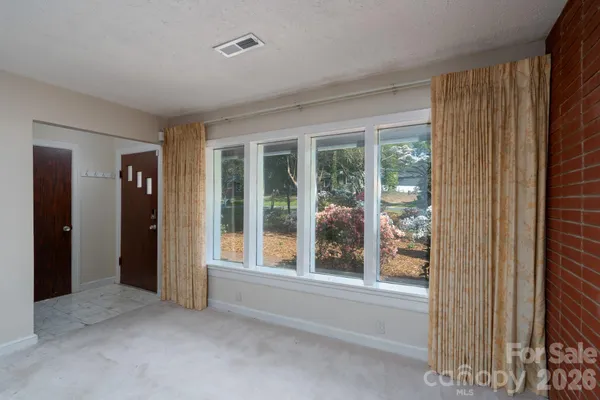 a view of an empty room with entrance and door