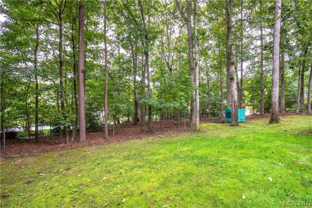 2306 Cranborne Road Midlothian, VA 23113 - Photo 22 of 23 a backyard of a house with lots of green space and trampoline