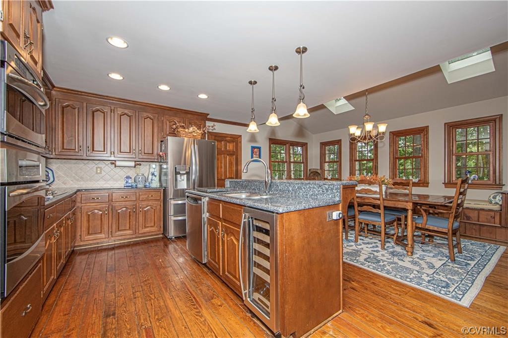 2306 Cranborne Road Midlothian, VA 23113 - Photo 4 of 23 a kitchen with stainless steel appliances granite countertop a stove top oven a kitchen island a sink a dining table and chairs