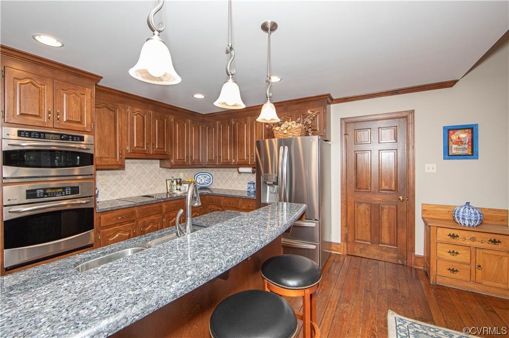 2306 Cranborne Road Midlothian, VA 23113 - Photo 5 of 23 a kitchen with stainless steel appliances granite countertop a sink refrigerator and cabinets