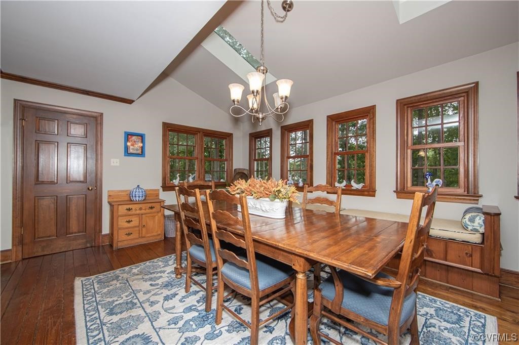 2306 Cranborne Road Midlothian, VA 23113 - Photo 6 of 23 a view of a dining room with furniture a chandelier and wooden floor