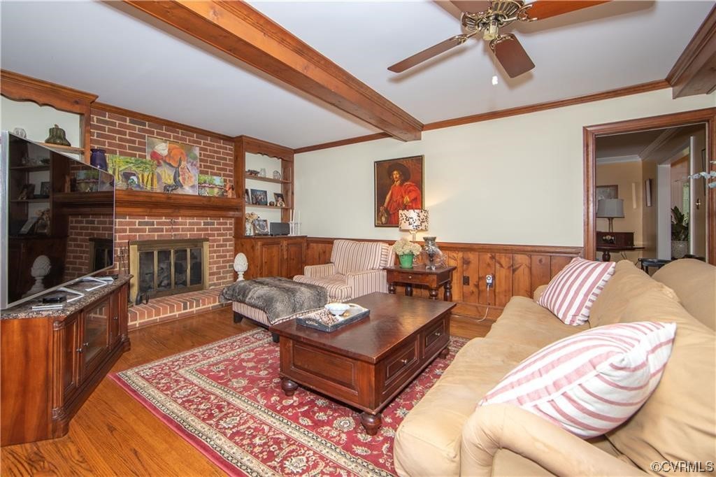 2306 Cranborne Road Midlothian, VA 23113 - Photo 7 of 23 a living room with furniture a flat screen tv and a fireplace